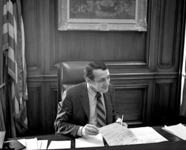 Harvey Milk sits at Mayor George Moscone's desk in 1978.