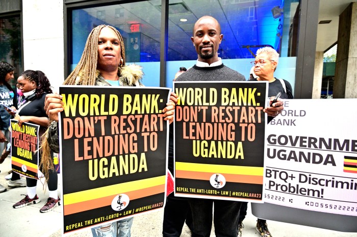 Advocates hold signs outside Uganda's Permanent Mission to the UN in Manhattan.