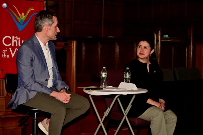 Moderator Juan Manuel Benítez (left) interviews State Senator Jessica Ramos of Queens.